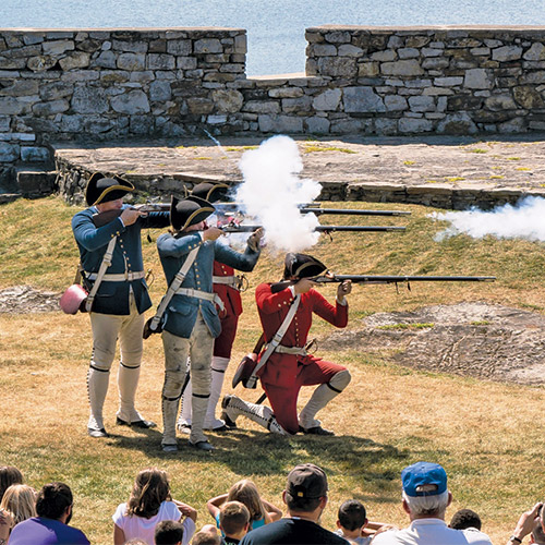 http://Men%20firing%20rifles%20during%20battle%20reenactment