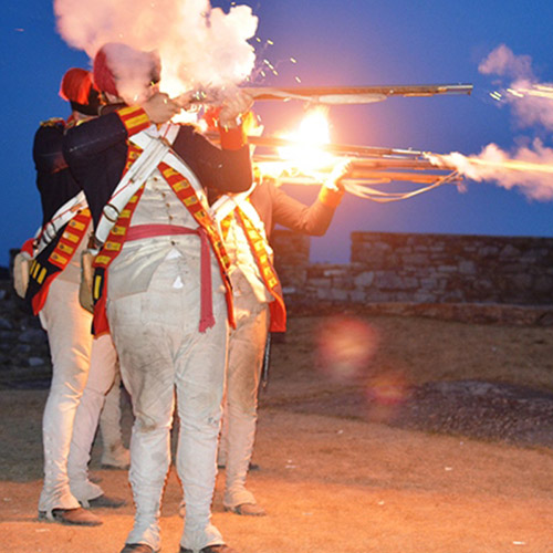 http://Men%20firing%20rifles%20during%20battle%20reenactment