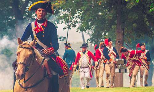 http://Man%20on%20horse%20with%20soldiers%20in%20the%20background