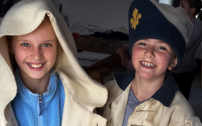 Two kids dressed up in soldier uniforms