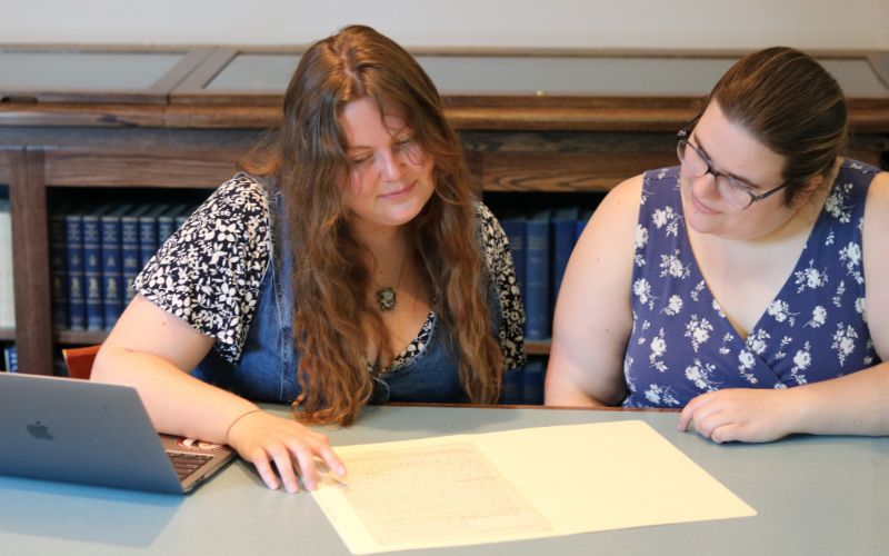 Two women researching archival document